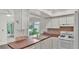 Well-equipped kitchen featuring white cabinetry and ample counter space at 454 San Jose Dr, Winter Haven, FL 33884