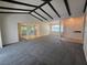 Open-concept living area featuring neutral paint, beams and seamless flow into the kitchen at 454 San Jose Dr, Winter Haven, FL 33884