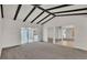 Open concept living room with neutral carpet and access to outdoor space at 454 San Jose Dr, Winter Haven, FL 33884