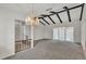 Living room featuring vaulted ceilings, exposed beams, and elegant lighting at 454 San Jose Dr, Winter Haven, FL 33884