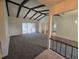 Spacious living room with a vaulted ceiling and dark wood beams, leading to an outdoor area at 454 San Jose Dr, Winter Haven, FL 33884