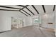 Bright living room with vaulted ceiling, exposed beams, and neutral carpet at 454 San Jose Dr, Winter Haven, FL 33884