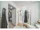 Bathroom featuring glass-enclosed shower and a nearby closet for convenient storage at 621 Silver Palm Dr, Haines City, FL 33844