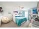 Bright primary bedroom featuring a large bed, and decor to include matching curtains and bedding at 621 Silver Palm Dr, Haines City, FL 33844