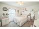 Cozy bedroom with lots of decor, neutral carpet flooring, and lots of natural light from the window at 621 Silver Palm Dr, Haines City, FL 33844