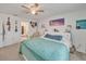 Cozy bedroom with a ceiling fan, carpeted floor, and decor on the white walls for a personalized space at 621 Silver Palm Dr, Haines City, FL 33844