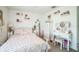 Charming bedroom with floral bedding, vanity table and stool, and neutral carpet flooring at 621 Silver Palm Dr, Haines City, FL 33844