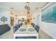 Open-concept dining area with access to the kitchen featuring a white table and seating for six at 621 Silver Palm Dr, Haines City, FL 33844