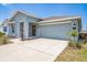 Beautiful one-story home with a large two car garage and well maintained landscaping in the front yard at 621 Silver Palm Dr, Haines City, FL 33844