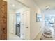 Bright hallway providing entrance to a bathroom, spare bedroom, and the main living area at 621 Silver Palm Dr, Haines City, FL 33844