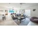A stylish living room is showcased, complete with tile floors, a comfortable sofa, and access to the dining area at 621 Silver Palm Dr, Haines City, FL 33844