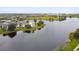 Scenic aerial view of a lake community with modern homes, lush green spaces, and tranquil waterfront at 12684 Willstatter Ave, Orlando, FL 32827