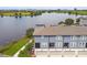 Aerial view of modern townhomes with lakefront scenery providing serene landscape and curb appeal at 12684 Willstatter Ave, Orlando, FL 32827