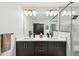 Modern bathroom featuring double vanity, and a walk-in shower with glass door and gray tile at 12684 Willstatter Ave, Orlando, FL 32827