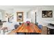 Open-concept dining area featuring hardwood floors, a wooden table, and modern decor, perfect for entertaining guests at 12684 Willstatter Ave, Orlando, FL 32827