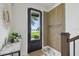 Modern entryway with wood accent wall and views of the lake at 12684 Willstatter Ave, Orlando, FL 32827