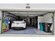 Spacious garage with a parked white car and ample storage solutions, ensuring organization and convenience at 12684 Willstatter Ave, Orlando, FL 32827