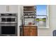 Elegant kitchen features built-in wine rack, oven, with a lovely view of the water at 12684 Willstatter Ave, Orlando, FL 32827