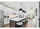 Contemporary kitchen features white cabinetry, a large island, and modern lighting, perfect for cooking and gathering at 12684 Willstatter Ave, Orlando, FL 32827