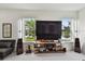Cozy living room with entertainment center overlooking the lake at 12684 Willstatter Ave, Orlando, FL 32827