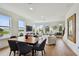 Spacious, open-concept living area with ample natural light, modern furnishings, and a view of the serene lake at 12684 Willstatter Ave, Orlando, FL 32827