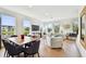 Bright, airy living room with hardwood floors, large windows, and modern decor perfect for relaxation and entertaining at 12684 Willstatter Ave, Orlando, FL 32827