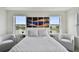 Bright bedroom featuring waterfront views from large windows and elegant contemporary decor at 12684 Willstatter Ave, Orlando, FL 32827
