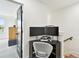 Bright office space with desk and chair, with view of the room beyond at 12684 Willstatter Ave, Orlando, FL 32827