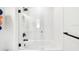 Modern walk-in shower features sleek glass door, dark fixtures, and white textured tile surround at 12684 Willstatter Ave, Orlando, FL 32827