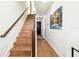 Bright staircase features hardwood steps and a modern wood handrail, leading to the upper level of the home at 12684 Willstatter Ave, Orlando, FL 32827