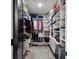 Spacious walk-in closet with custom shelving, drawers, and ample storage for clothing and accessories at 12684 Willstatter Ave, Orlando, FL 32827
