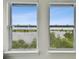 Double windows provide panoramic view of the lake with lush green trees at 12684 Willstatter Ave, Orlando, FL 32827