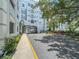 Beautifully landscaped entrance with mature trees and a charming archway leading to the property at 202 E South St # 5050, Orlando, FL 32801