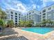 Beautiful community pool surrounded by lounge chairs and lush landscaping, perfect for relaxation at 202 E South St # 5050, Orlando, FL 32801
