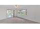 Bright bedroom features neutral carpet, ceiling fan, and sliding doors to a screened lanai at 3582 Milano Ave, Lakeland, FL 33803