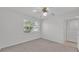 Bright bedroom featuring neutral carpet, ceiling fan, and white-painted walls at 3582 Milano Ave, Lakeland, FL 33803
