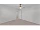 The spacious carpeted bedroom features a ceiling fan and convenient access to the bathroom at 3582 Milano Ave, Lakeland, FL 33803