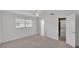 Well-lit bedroom with a ceiling fan, walk-in closet, and an en-suite bathroom at 3582 Milano Ave, Lakeland, FL 33803