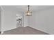 Carpeted dining room with decorative lighting fixtures and access to the kitchen at 3582 Milano Ave, Lakeland, FL 33803
