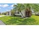 Corner view of the house exterior featuring neatly trimmed hedges and a palm tree at 3582 Milano Ave, Lakeland, FL 33803