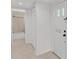 Hallway view leading to a bathroom, featuring a closet and tile floors at 3582 Milano Ave, Lakeland, FL 33803