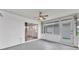 Enclosed sunroom featuring a ceiling fan, neutral paint, and sliding windows to the backyard at 3582 Milano Ave, Lakeland, FL 33803
