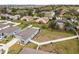 Aerial shot highlighting houses with vinyl fences, lush green spaces, and beautiful landscaping in the area at 389 Singing Sands Cir, Lake Wales, FL 33859