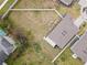 Backyard view showing fenced perimeter, small patio, and view of surrounding homes in neighborhood at 389 Singing Sands Cir, Lake Wales, FL 33859