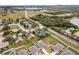 Aerial view showcasing neighborhood houses nestled between a highway, lakes, and lush green spaces at 389 Singing Sands Cir, Lake Wales, FL 33859