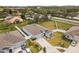 Aerial view of a well-kept homes featuring vinyl fenced yard, landscaped yard, and a concrete driveway at 389 Singing Sands Cir, Lake Wales, FL 33859