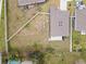 Backyard aerial view showing fenced perimeter, small patio, and view of surrounding homes in neighborhood at 389 Singing Sands Cir, Lake Wales, FL 33859