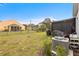 Expansive backyard featuring a screened-in patio and well-maintained lawn at 389 Singing Sands Cir, Lake Wales, FL 33859
