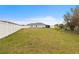 Large, open backyard with white fence, offering plenty of space at 389 Singing Sands Cir, Lake Wales, FL 33859