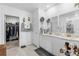 Bathroom featuring double sinks, hexagon shelves, decor and a walk-in closet with organized storage at 389 Singing Sands Cir, Lake Wales, FL 33859